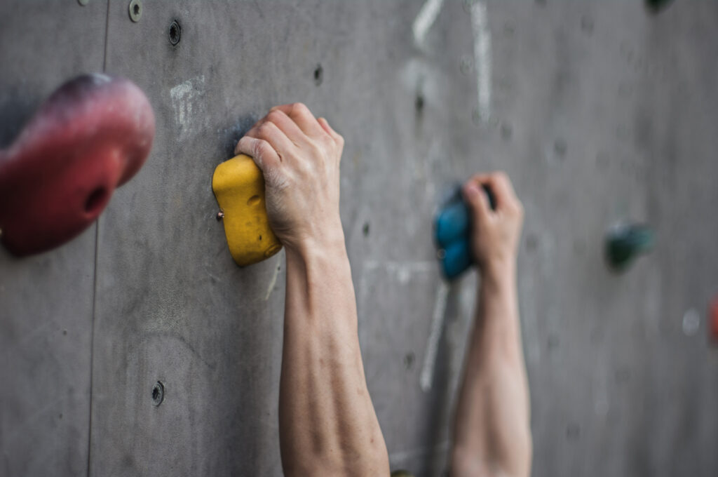 Gripping on holds or rock can lead to whats known as the pump, eventually if you don't rest between attempts you are stroking the wall. This can improve with practice and recovery can speed up, but when you pair this with pain your body has a lot to contend with.