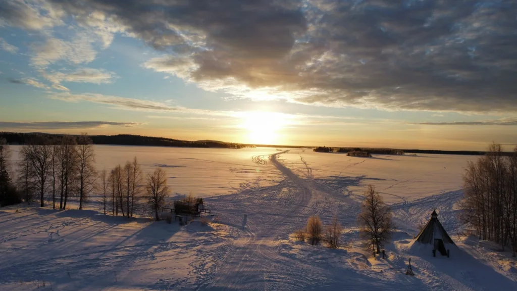 Snowmobiling through lapland wilderness near Apukka, Rovaniemi