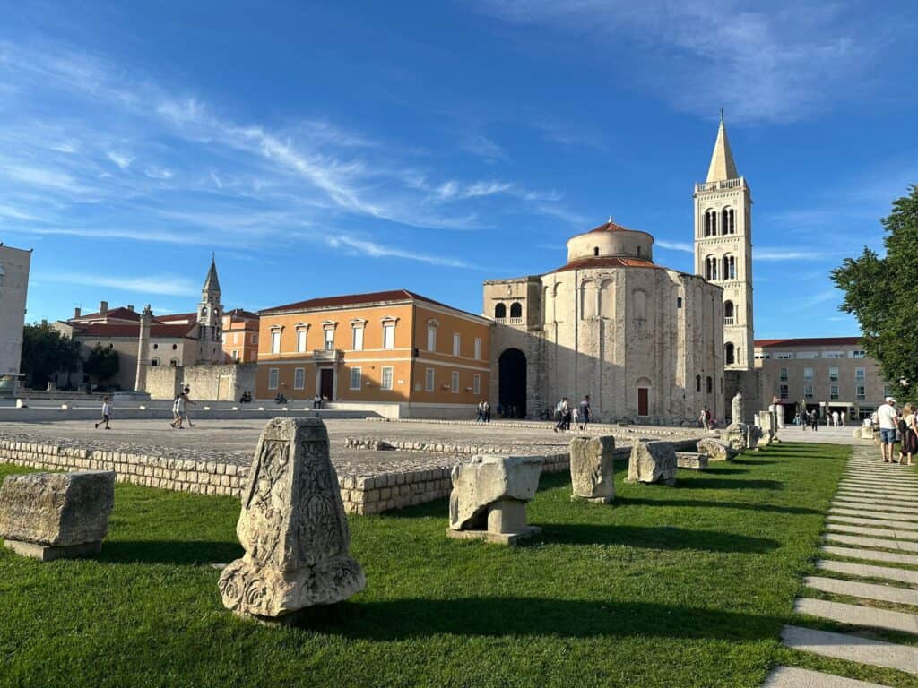 The roman forum in Zadar with stone building, a tower and a stone monuments